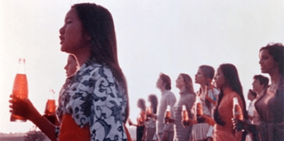 people on hillside with Coke bottles