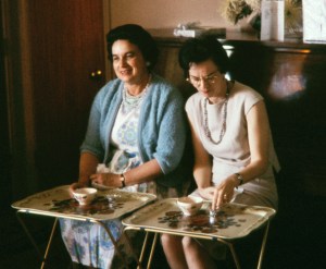 two women eating on TV trays