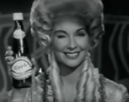 woman holds Ripple bottle and winks